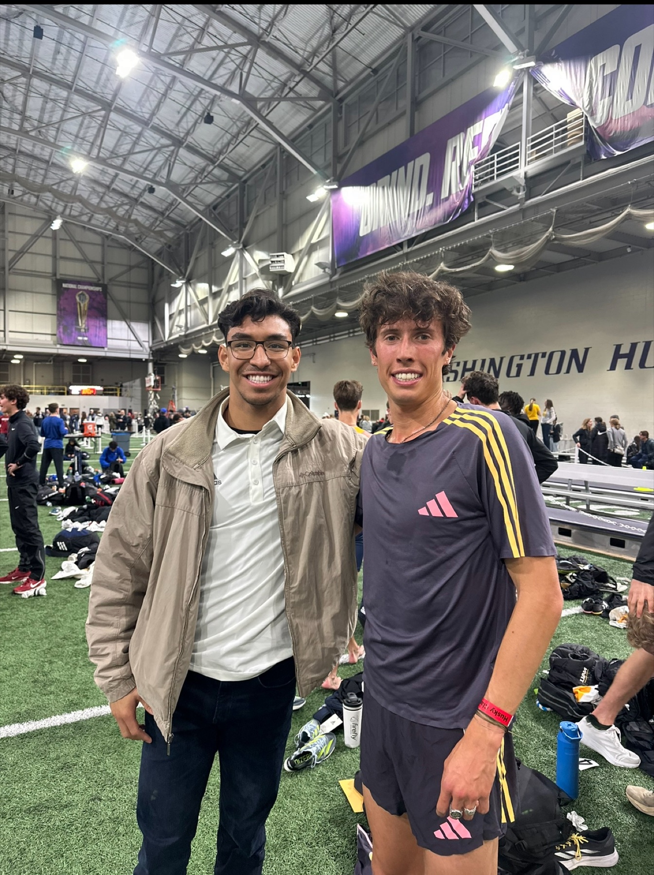 Jacob Resendez with an athlete after an indoor track meet