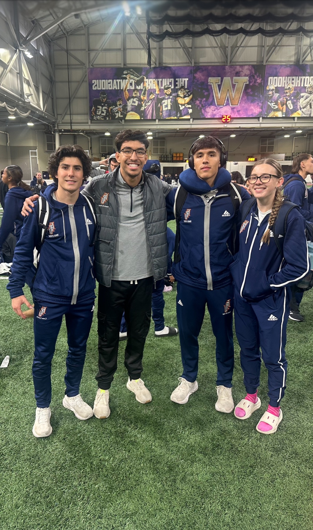 Jacob Resendez with Fresno Pacific athletes at an indoor track meet