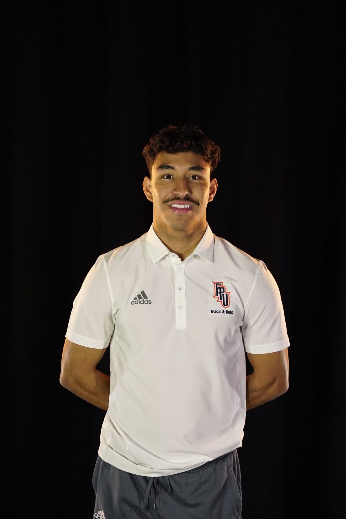 Coach Jacob Resendez in Fresno Pacific track and field coaching apparel