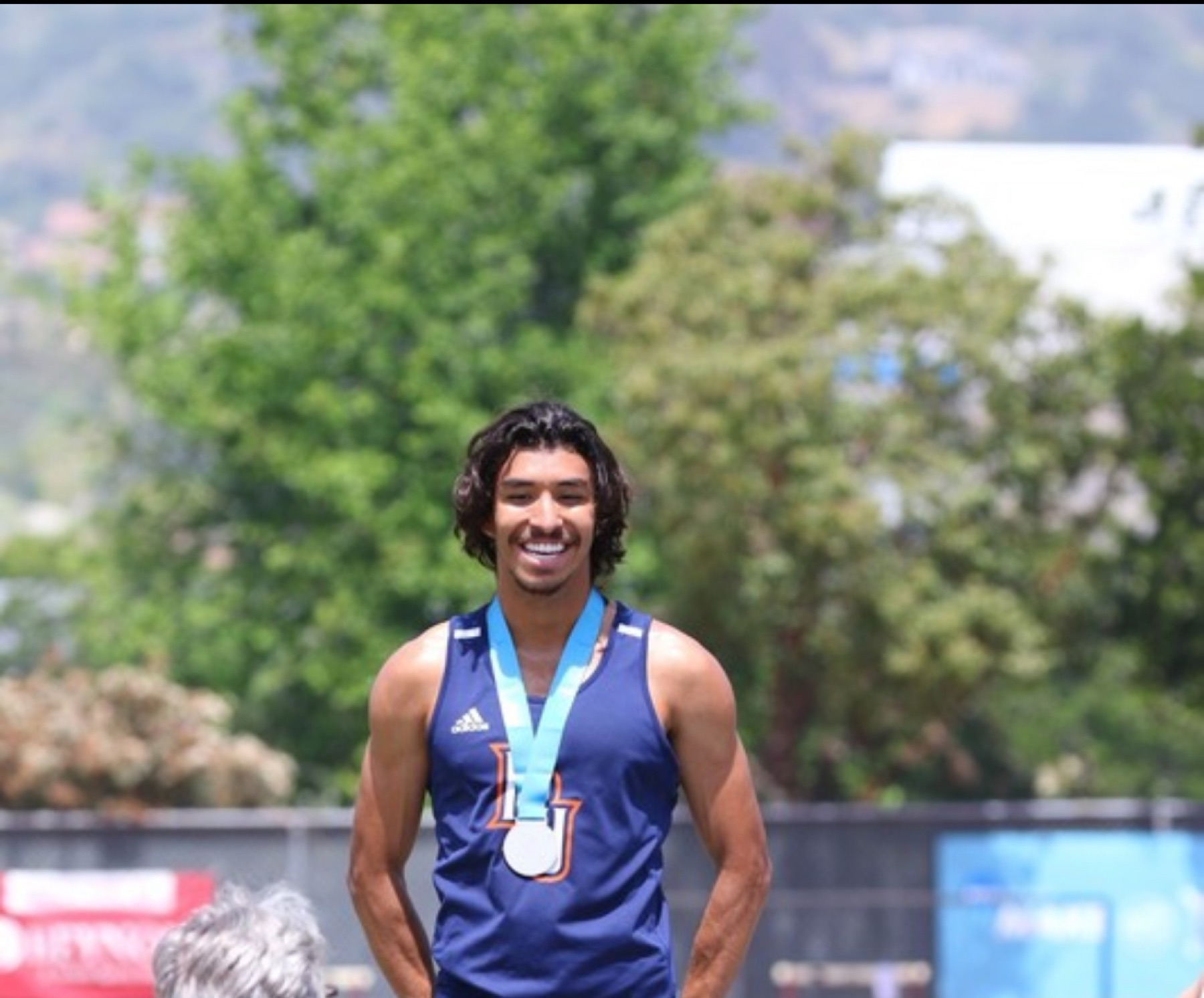 Jacob Resendez wearing a PacWest championship medal